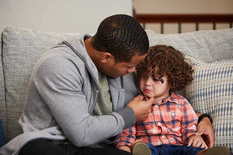 dad comforting upset child